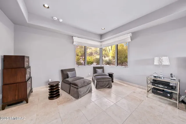 a living room with furniture a large window and a flat screen tv