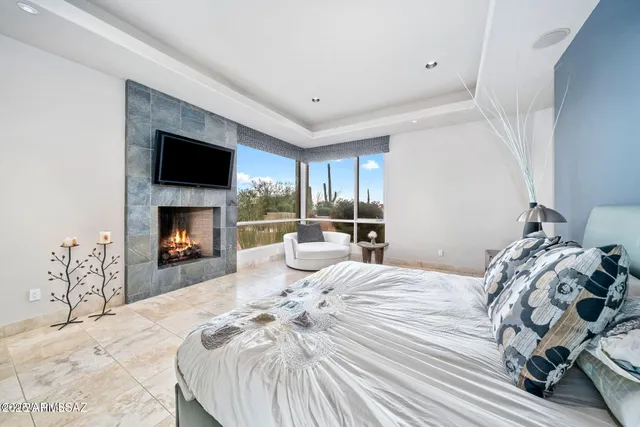a bedroom with a bed and a fireplace