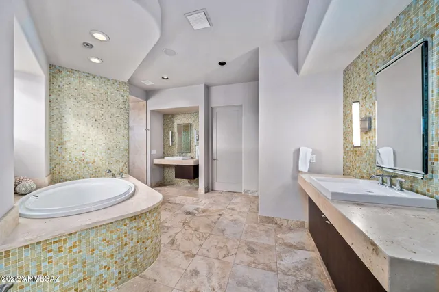 a spacious bathroom with a granite countertop sink toilet a mirror and shower