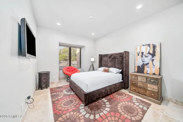 a bedroom with a large bed and a flat screen tv