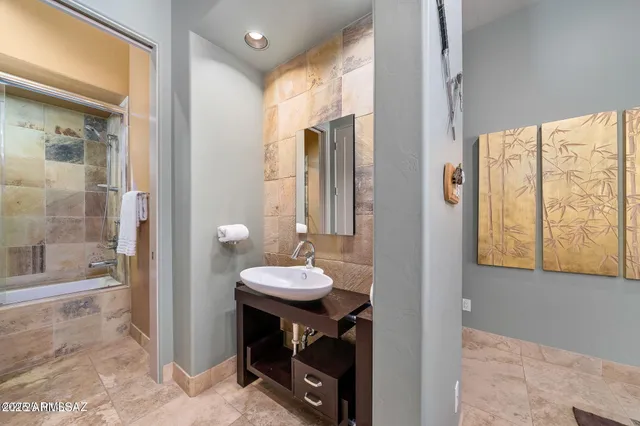 a bathroom with a sink a toilet and a shower