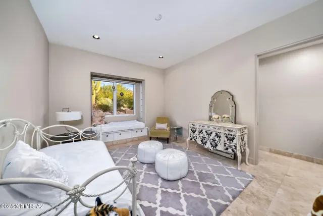 a bedroom with furniture and a window