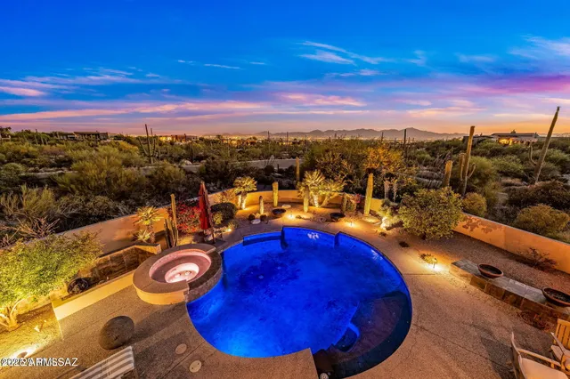 a view of a swimming pool with outdoor seating