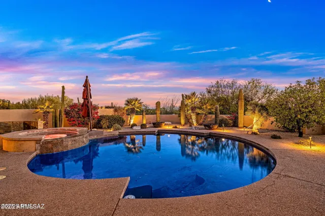a view of a swimming pool with outdoor seating