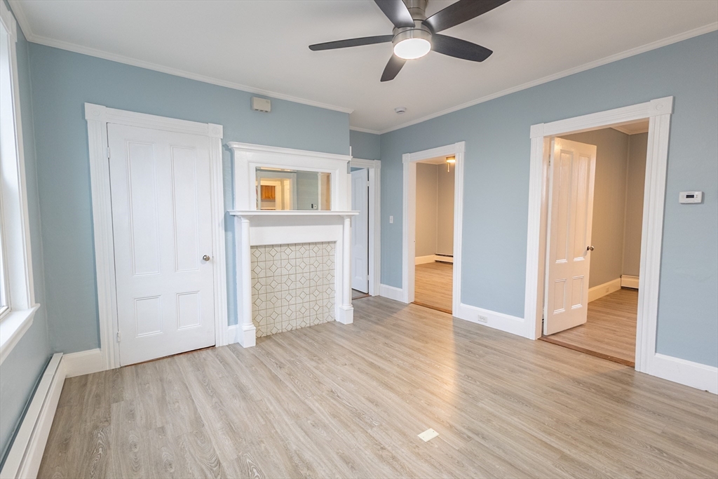 210 North Street, Unit 1 Salem, MA 01970 - Photo 6 of 14 an empty room with wooden floor a ceiling fan and windows
