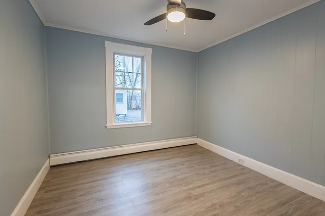 wooden floor in an empty room with a window