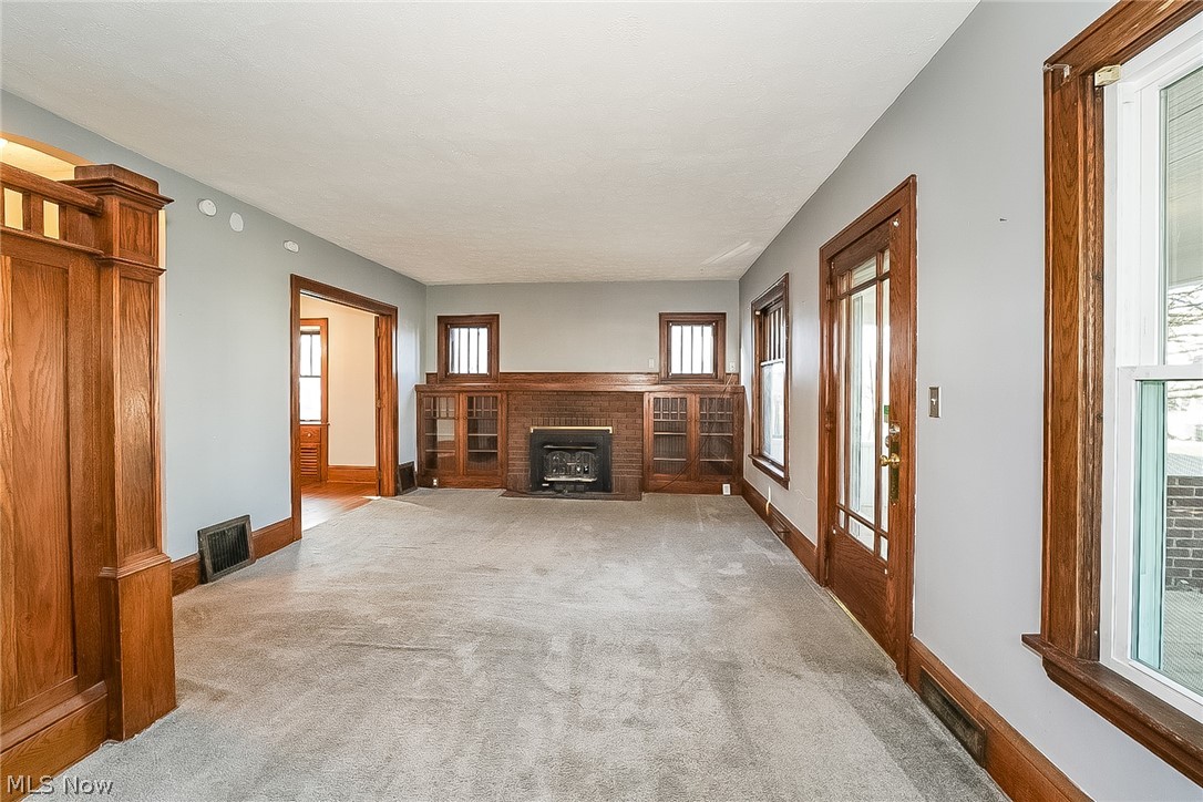 911 Dan Street Akron, OH 44310 - Photo 3 of 20 Living room featuring a fireplace and light colored carpet