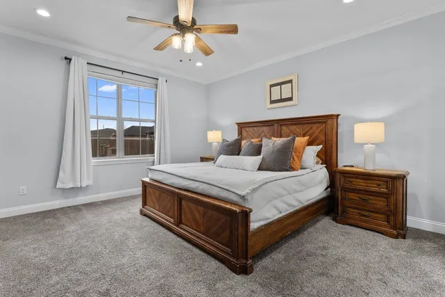 a bed sitting in a spacious bedroom next to a window