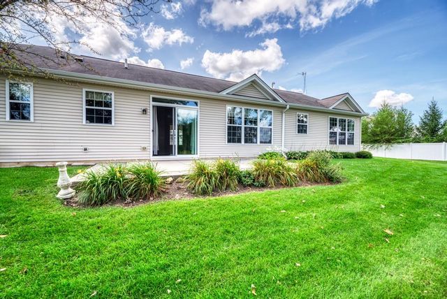 a view of a back yard with flower plants