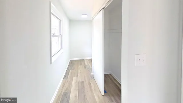 a view of a room with wooden floor and a window