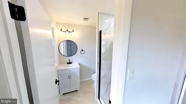 a bathroom with a sink mirror and vanity