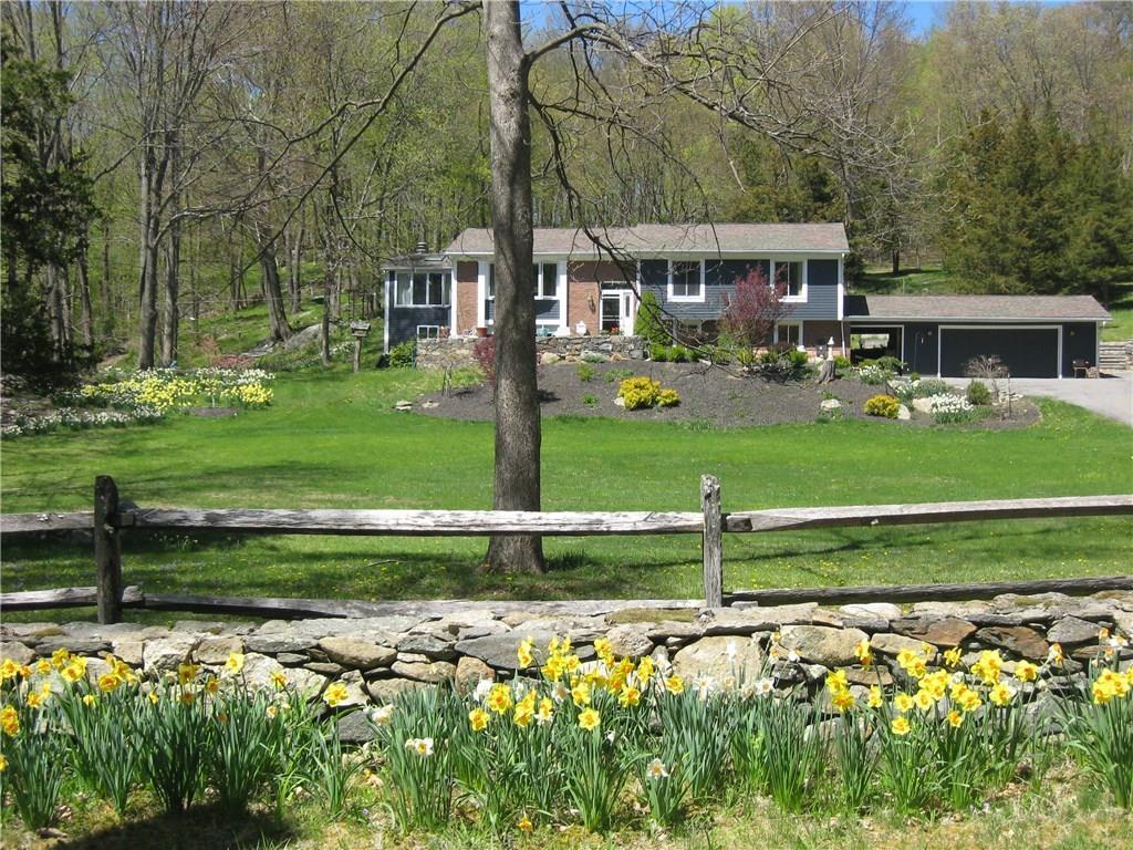 28 Clark Hill Road Sharon, CT 06069 - Photo 1 of 1 a front view of a house with a yard table and chairs