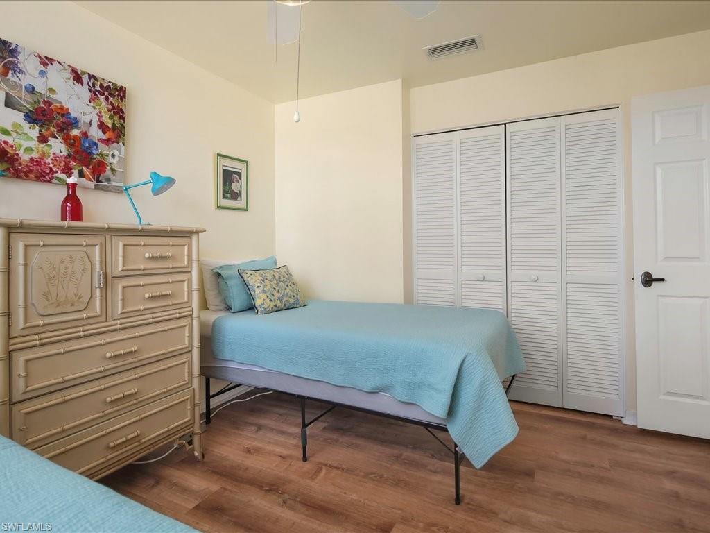 5550 Heron Point Drive, Unit 105 Naples, FL 34108 - Photo 11 of 20 a bedroom with a bed and a window