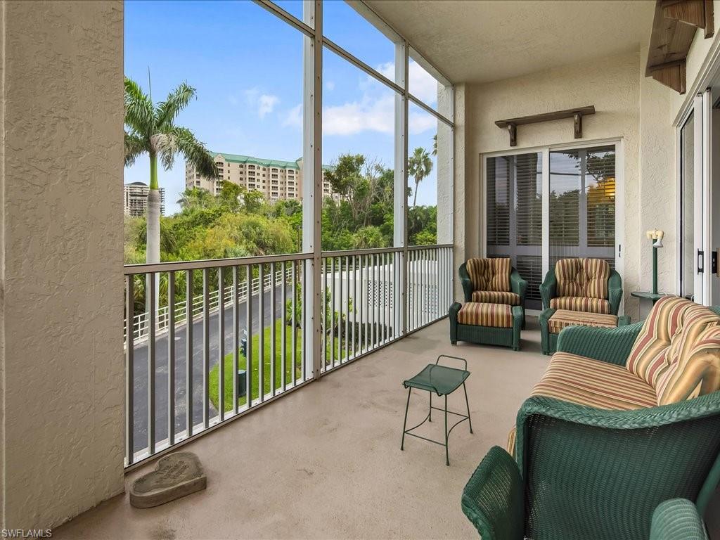5550 Heron Point Drive, Unit 105 Naples, FL 34108 - Photo 16 of 20 a balcony with furniture and a potted plant