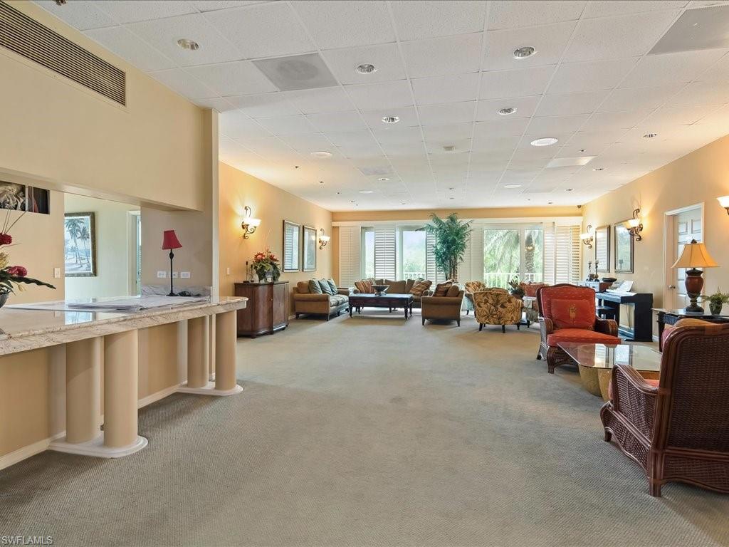 5550 Heron Point Drive, Unit 105 Naples, FL 34108 - Photo 20 of 20 a large room with lots of white furniture