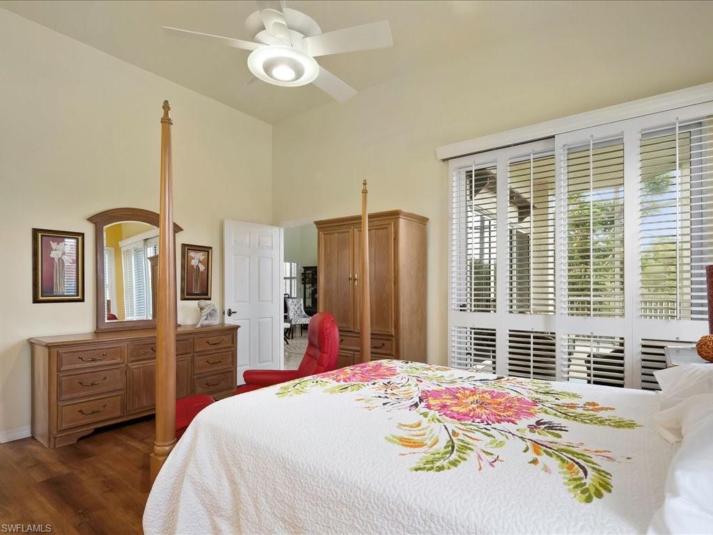 5550 Heron Point Drive, Unit 105 Naples, FL 34108 - Photo 8 of 20 a bedroom with a bed dresser and a large window