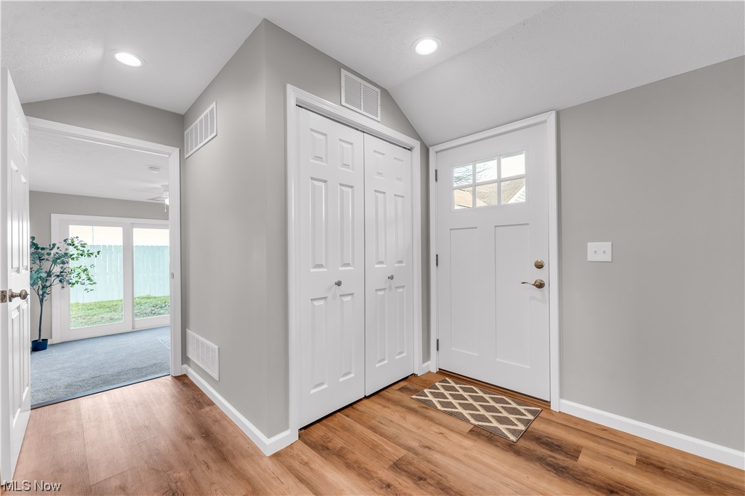 7501 Southland Road Mentor, OH 44060 - Photo 19 of 21 Entryway with light hardwood / wood-style floors, ceiling fan, and lofted ceiling