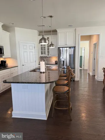 a view of a house with a wooden deck and furniture