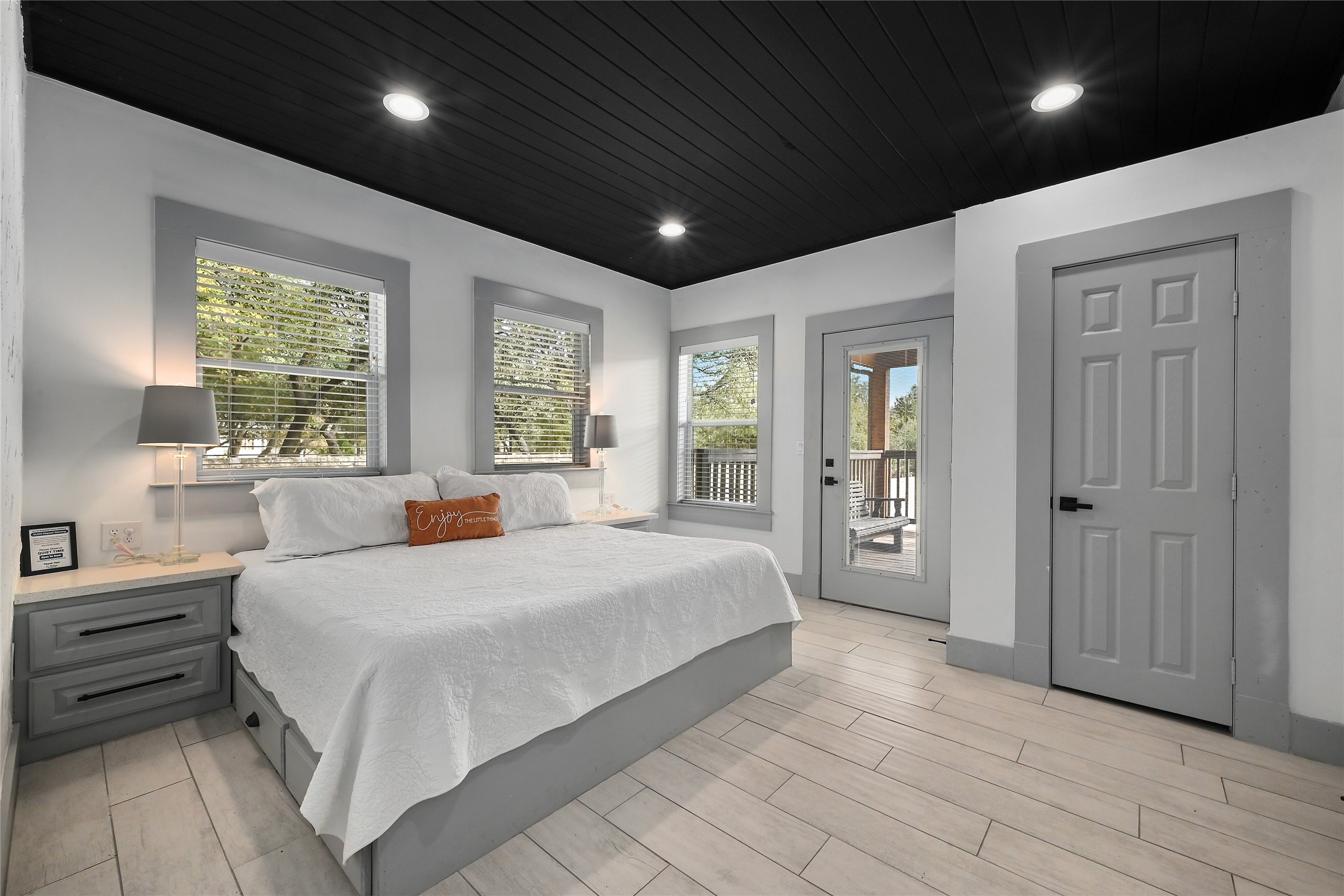 2903 Oak Ridge Drive Spicewood, TX 78669 - Photo 6 of 33 Main house Downstairs Bedroom with access to the rear porch, wood tiled floors, multiple windows, wooden ceiling, and recessed lighting