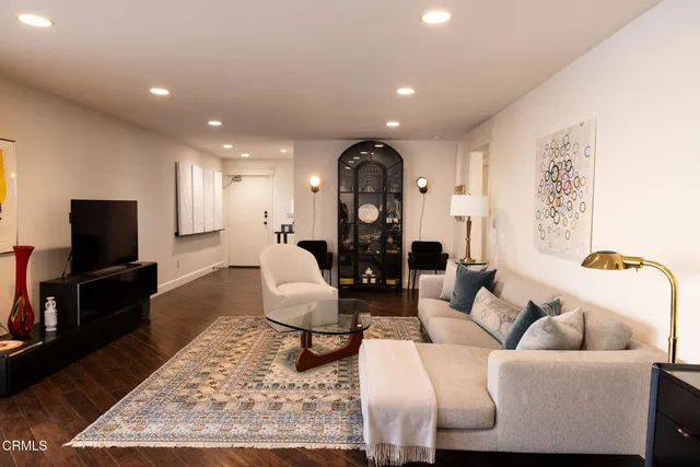 a living room with furniture and wooden floor
