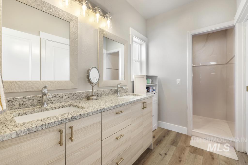1020 13th Street Rupert, ID 83350 - Photo 19 of 30 Full bath with double vanity and light wood-type flooring