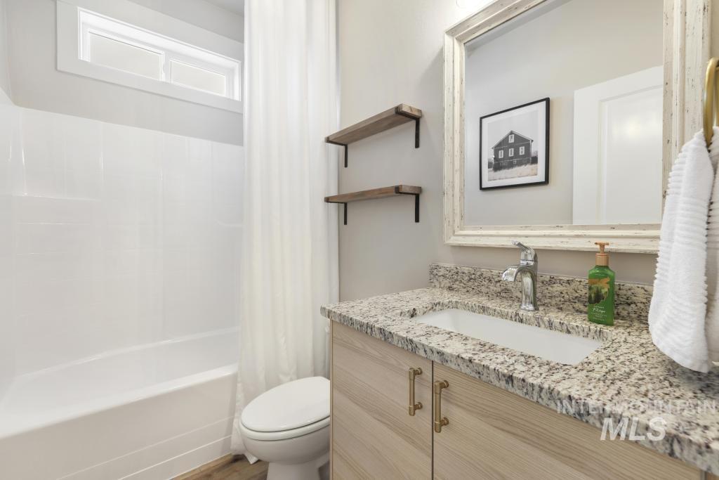 1020 13th Street Rupert, ID 83350 - Photo 23 of 30 Bathroom with vanity and shower / bath combination with curtain