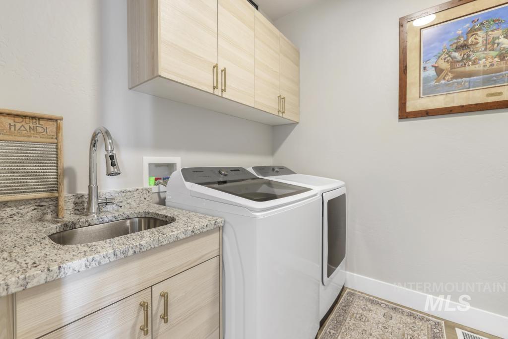 1020 13th Street Rupert, ID 83350 - Photo 26 of 30 Laundry room featuring washer and dryer and cabinet space