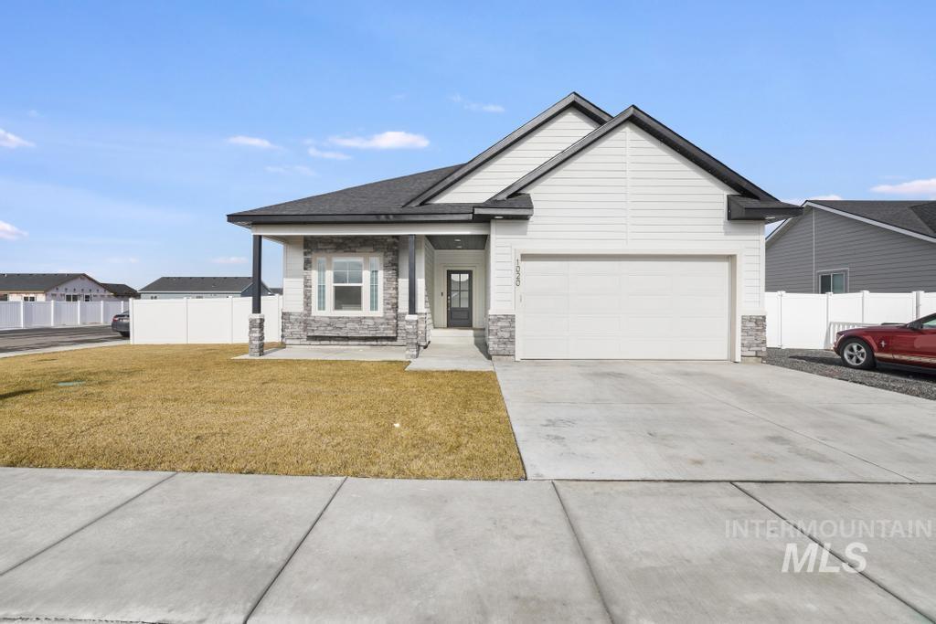 1020 13th Street Rupert, ID 83350 - Photo 3 of 30 View of front of house with concrete driveway, a porch, an attached garage, and stone siding