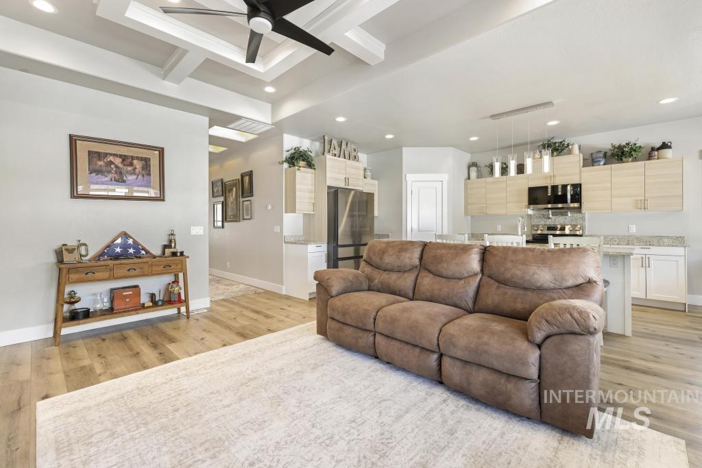1020 13th Street Rupert, ID 83350 - Photo 10 of 30 Living room featuring light wood finished floors, ceiling fan, recessed lighting, and coffered ceiling