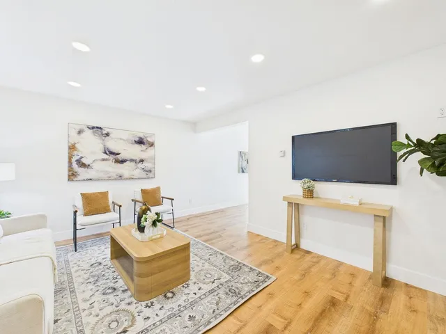 a large white bed in a white room