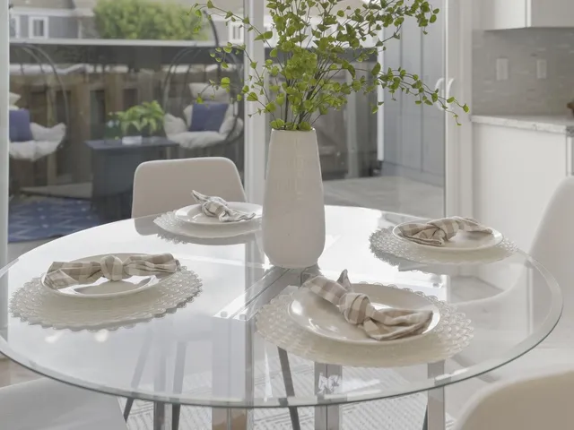a table with chairs and a potted plant