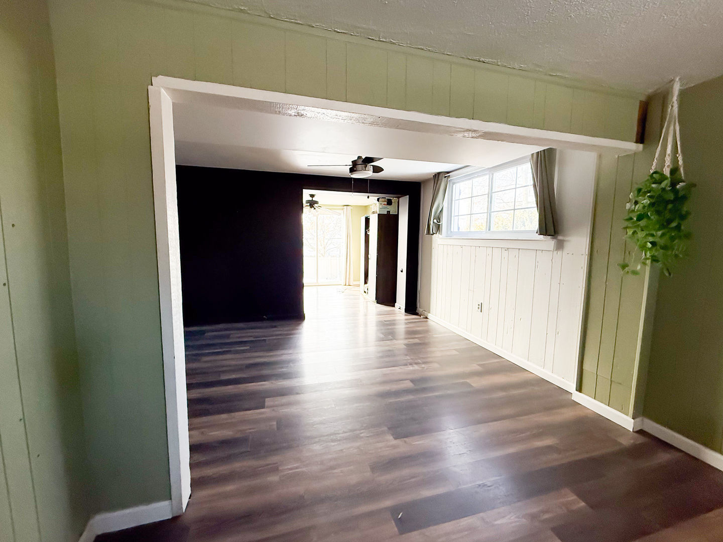 107 Arcadia Avenue Romeoville, IL 60446 - Photo 5 of 51 a view of a hallway with wooden floor and a living room