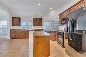 a kitchen that has a sink a stove and a oven