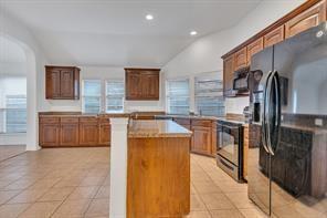 13117 Larks View Point Fort Worth, TX 76244 - Photo 12 of 26 a kitchen with stainless steel appliances granite countertop a stove a sink and a refrigerator