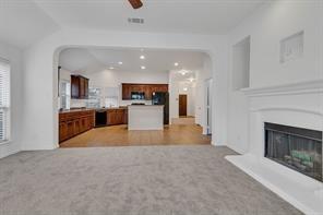 13117 Larks View Point Fort Worth, TX 76244 - Photo 15 of 26 a kitchen with stainless steel appliances granite countertop a stove top oven a sink and a refrigerator