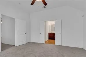 an empty room with chandelier fan