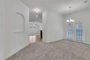 a view of an empty room with a kitchen