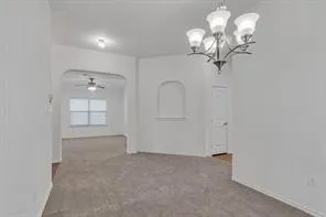 a view of a chandelier in big room and chandelier