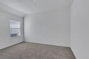 a view of an empty room and a window