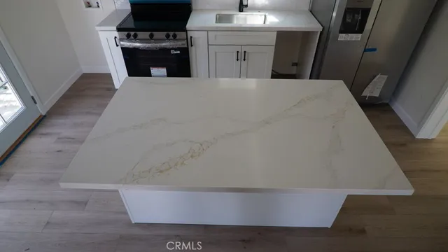 a view of kitchen and wooden floor