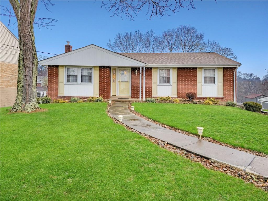 2013 Cutter Drive McKees Rocks, PA 15136 - Photo 1 of 25 a front view of a house with a yard and garage