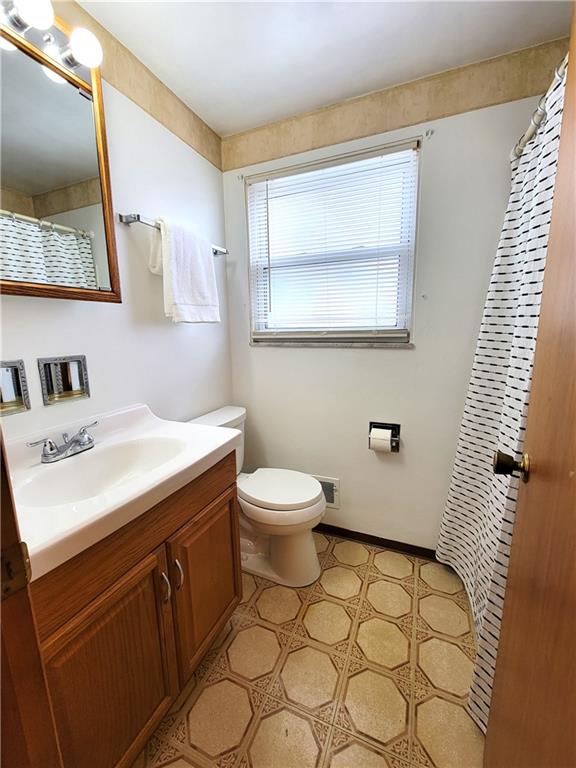 2013 Cutter Drive McKees Rocks, PA 15136 - Photo 14 of 25 a bathroom with a sink a toilet and mirror