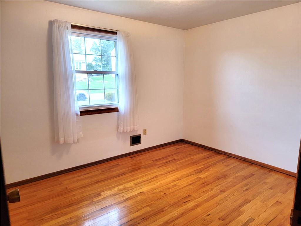 2013 Cutter Drive McKees Rocks, PA 15136 - Photo 18 of 25 an empty room with wooden floor and windows