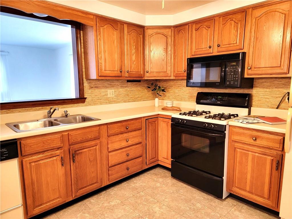 2013 Cutter Drive McKees Rocks, PA 15136 - Photo 7 of 25 a kitchen with stainless steel appliances granite countertop a stove a sink and a microwave