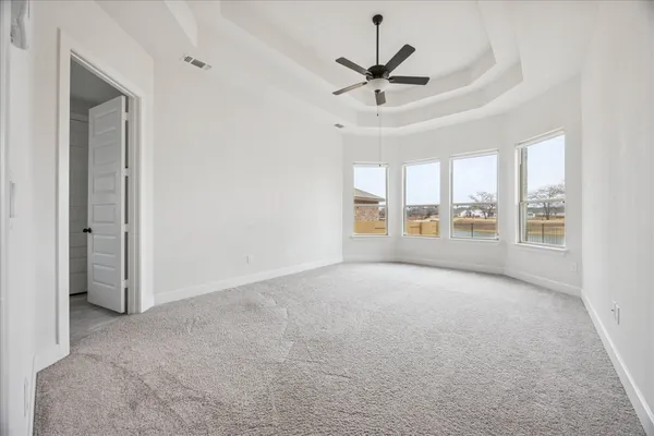 a view of a livingroom with a ceiling fan and window