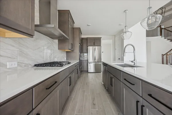 a large kitchen with a stove and a sink