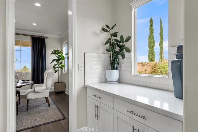 a kitchen with stainless steel appliances granite countertop a white table and chairs