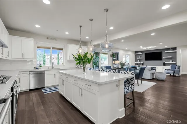 a kitchen with stainless steel appliances granite countertop a stove microwave and refrigerator