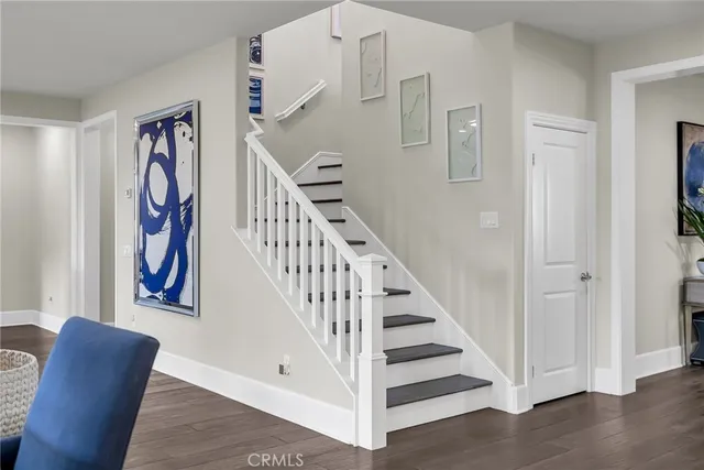 a living room with furniture a rug and a flat screen tv