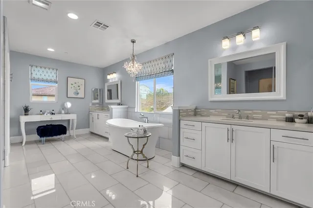 a spacious bathroom with a sink a light fixture and a window